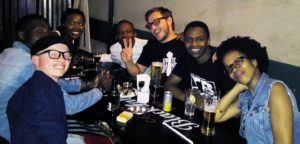 John Kimbio having drinks with colleagues
