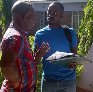 Bruce Tushabe chatting with workshop participant